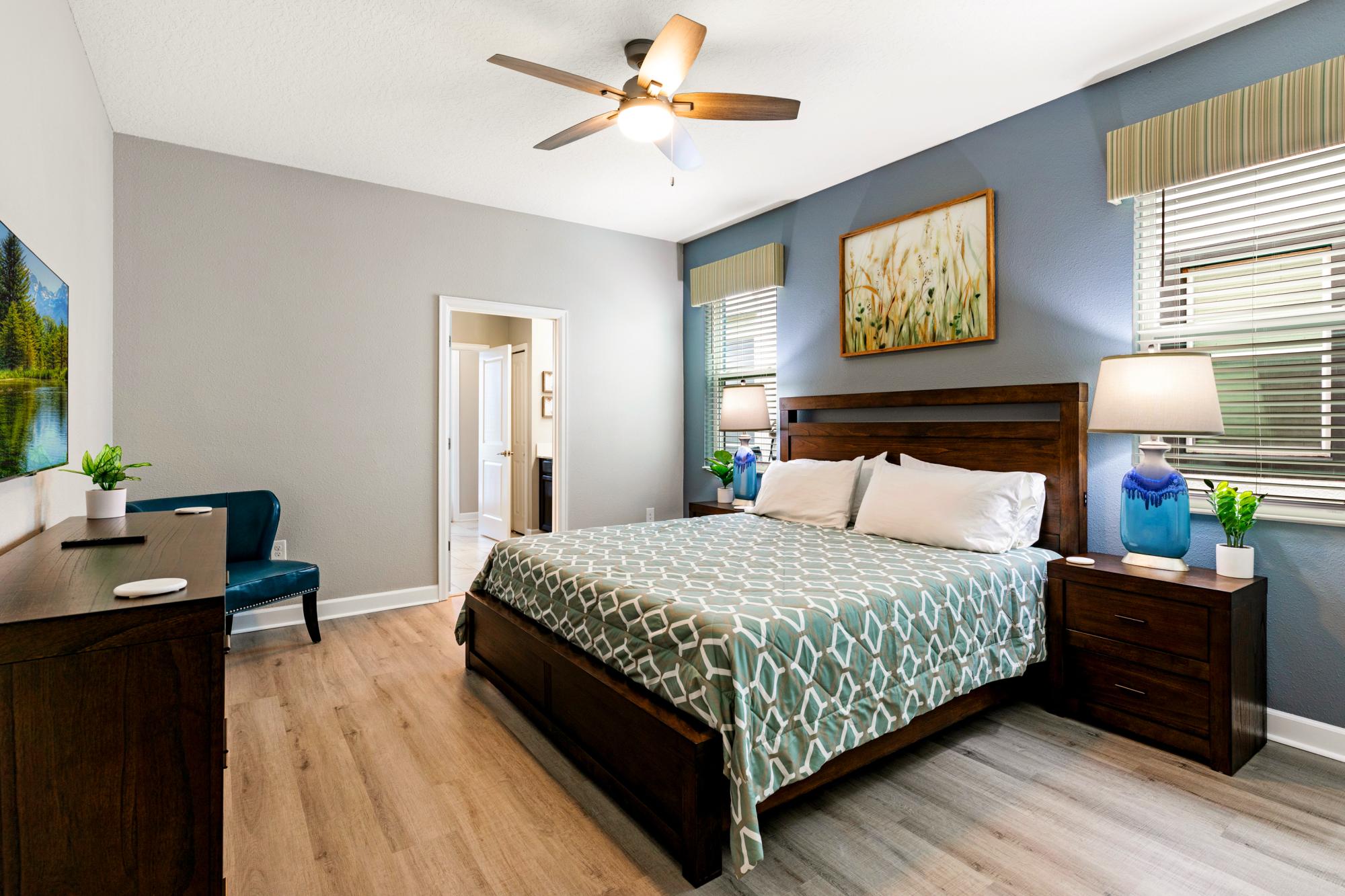The primary king en suite with 43 inch HD Smart TV, 14 inch memory foam mattress and pool access - In This 8 bedroom Top Rated Luxury Champions Gate Vacation Rental By Owner