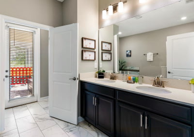 Main bathroom - double sinks, walk-in shower, soaking tub with door to pool