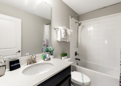Bathroom by movie theater - bath/shower combo and single sink