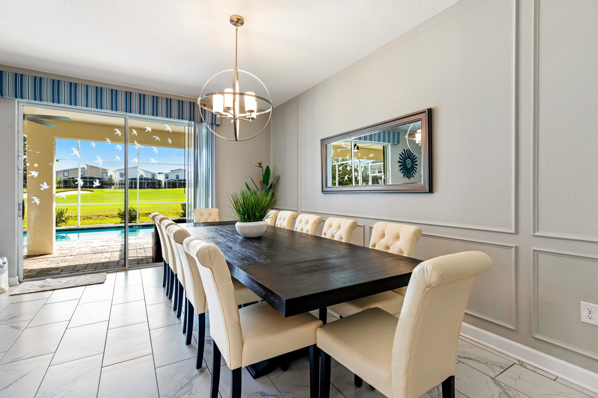 Seating for 12 on the large dining room table overlooking the salt water pool